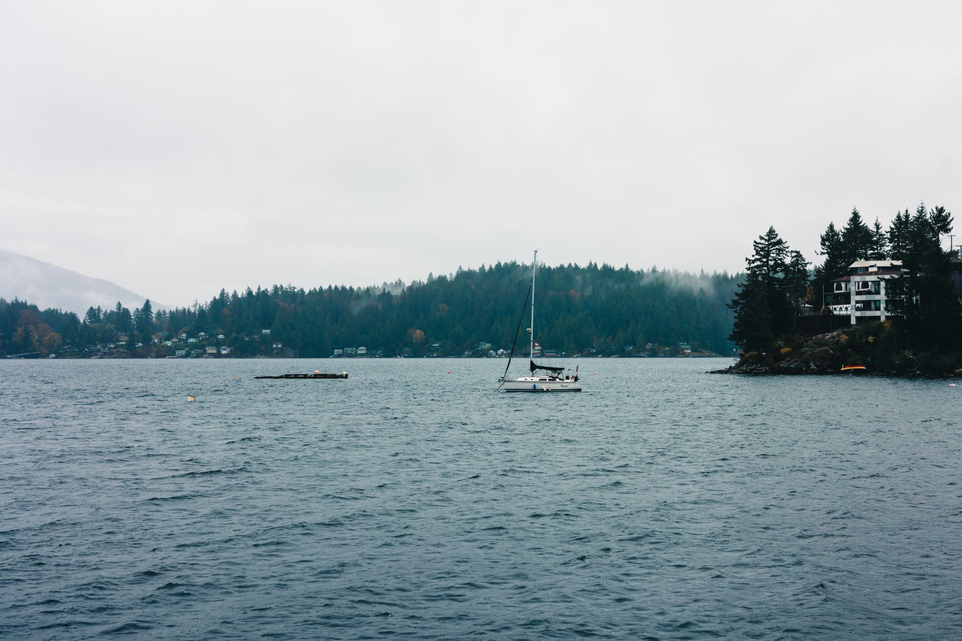 A lone sailboat in fog off the Sunshine Coast — Desolation Sound mood
